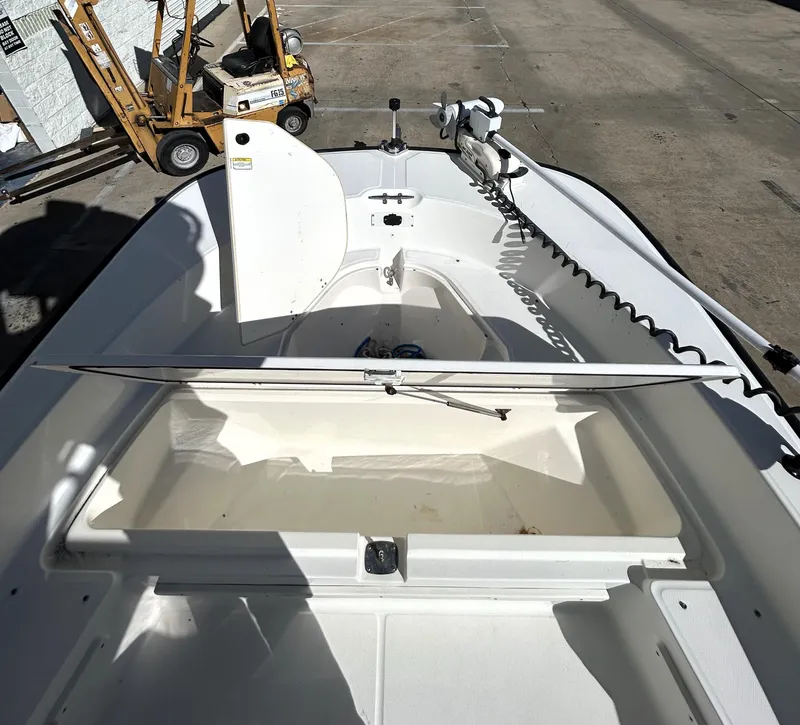 Slide: The Image of 2015 Boston Whaler 210 Montauk boat interior with open storage compartment. - 12