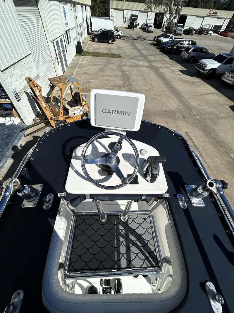 Slide: The Image of 2015 Boston Whaler 210 Montauk boat with Garmin navigation system, docked in a parking area. - 14