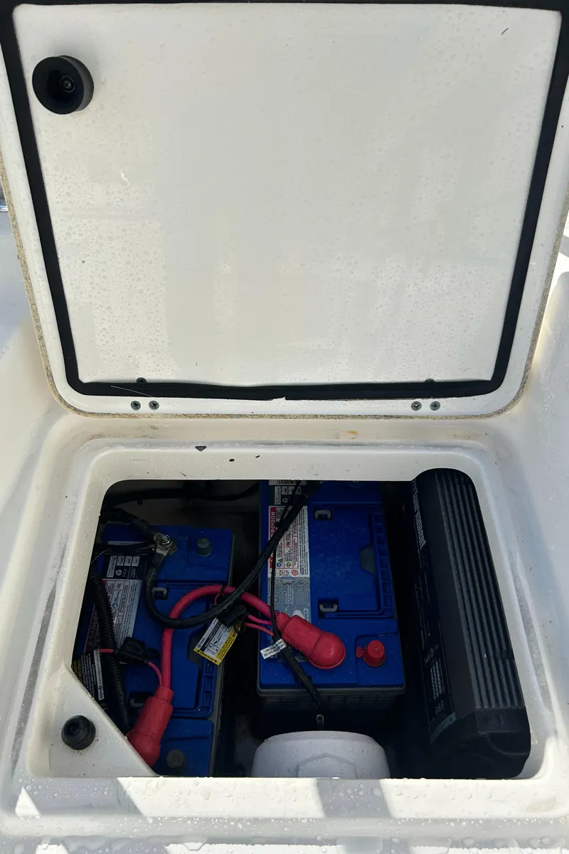 Slide: The Image of 2015 Boston Whaler 210 Montauk battery compartment with dual batteries and wiring. - 19