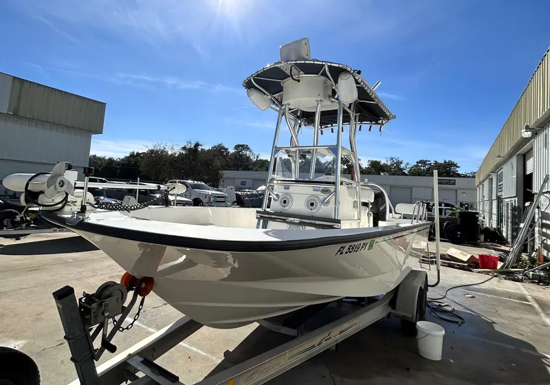 Slide: The Image of 2015 Boston Whaler 210 Montauk boat on trailer in sunny outdoor setting. - 3