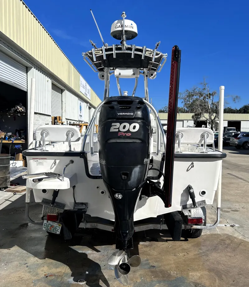 Slide: The Image of 2015 Boston Whaler 210 Montauk boat with 200hp engine, parked outdoors. - 6
