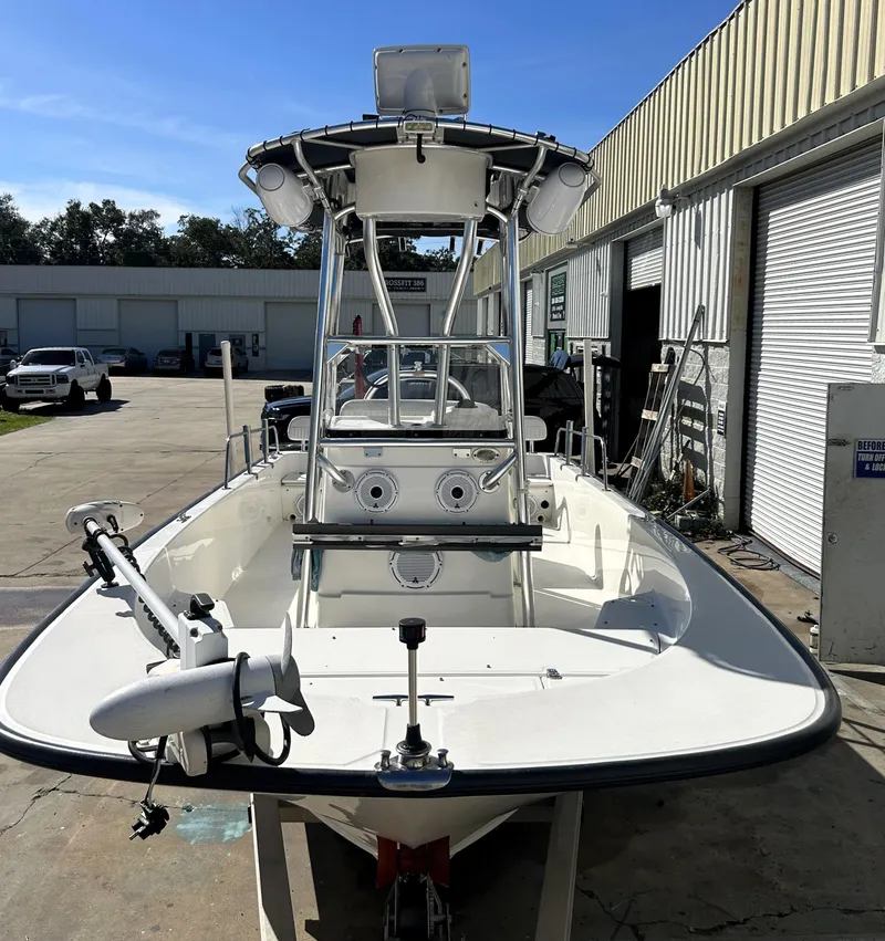 Slide: The Image of 2015 Boston Whaler 210 Montauk boat docked at a marina, featuring a center console. - 7