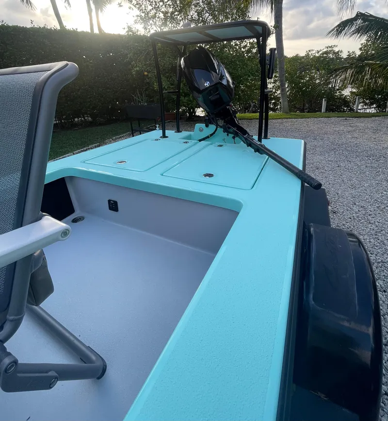 Slide: The Image of 2024 Cayo Boatworks 173 with outboard motor, turquoise deck, and seating. - 29