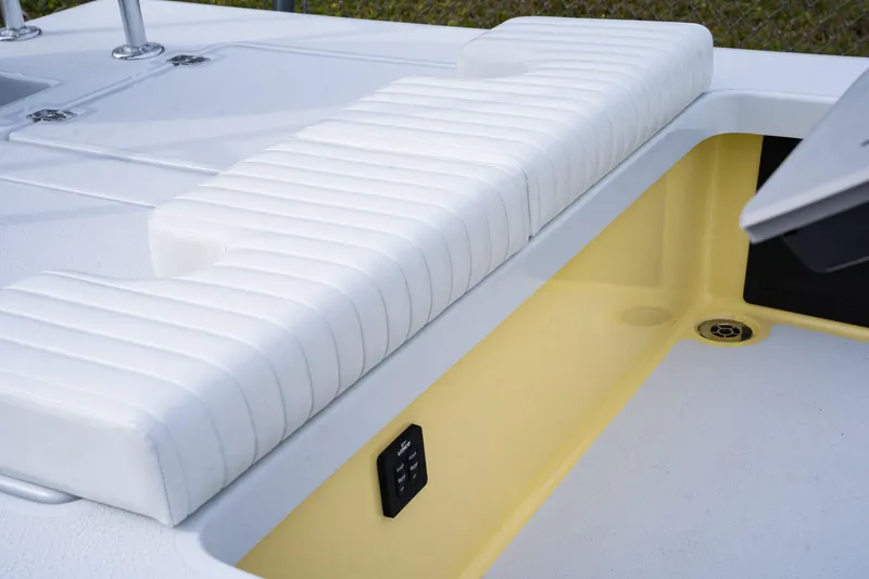 Slide: The Image of 2024 Cayo Boatworks 173 interior with white cushioned seating and yellow storage compartment. - 3