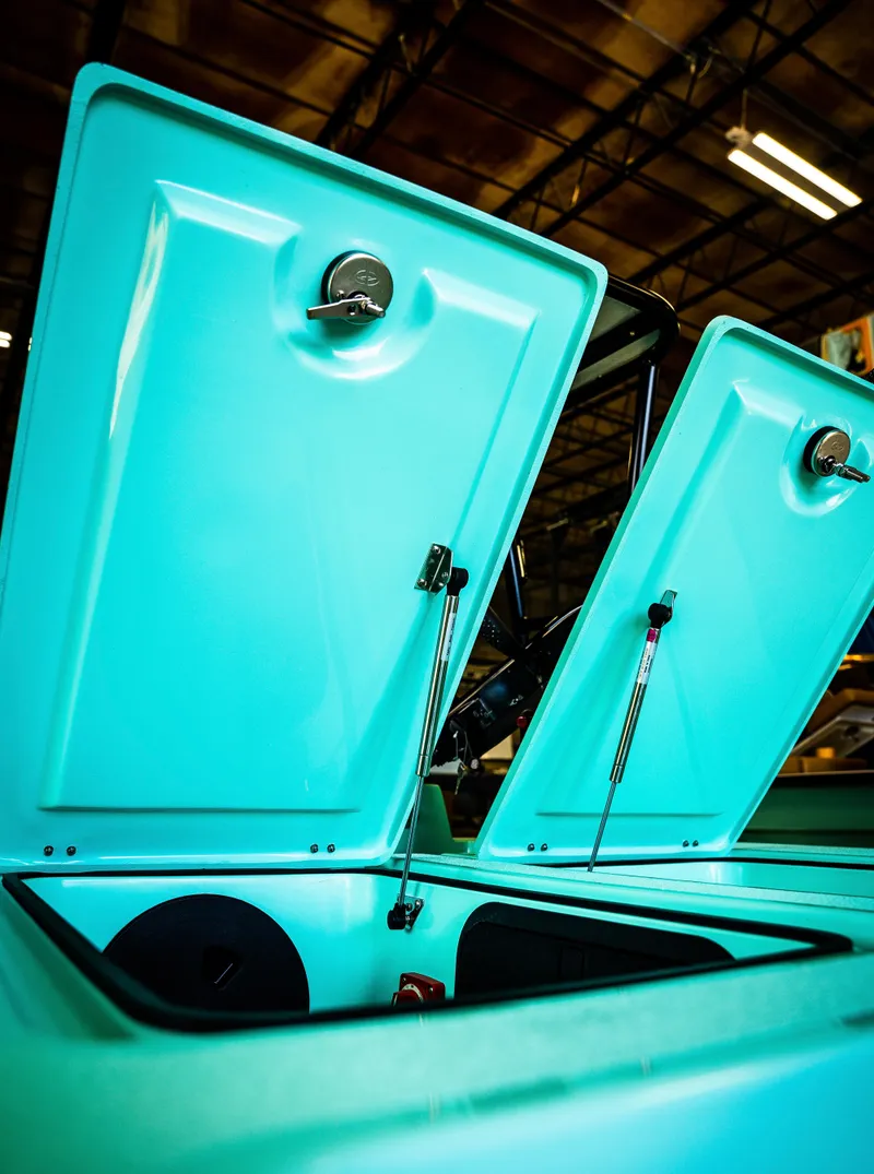 Slide: The Image of 2024 Cayo Boatworks 173 with open storage compartments in a warehouse. - 32