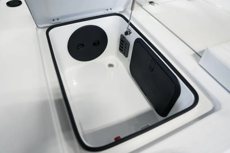 Slide: The Image of 2024 Cayo Boatworks 173 storage compartment with black lid and drain. - 49