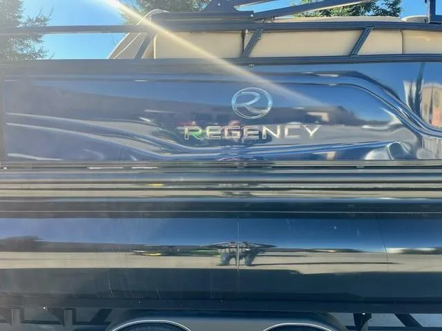 Slide: The Image of 2024 Regency 250 LE3 pontoon boat rear view with logo. - 3
