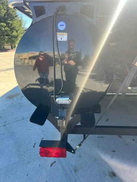 Slide: The Image of 2024 Regency 250 LE3 boat trailer with rear light and hitch. - 6