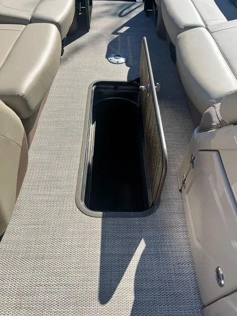 Slide: The Image of 2024 Regency 250 LE3 boat interior with open storage compartment. - 9