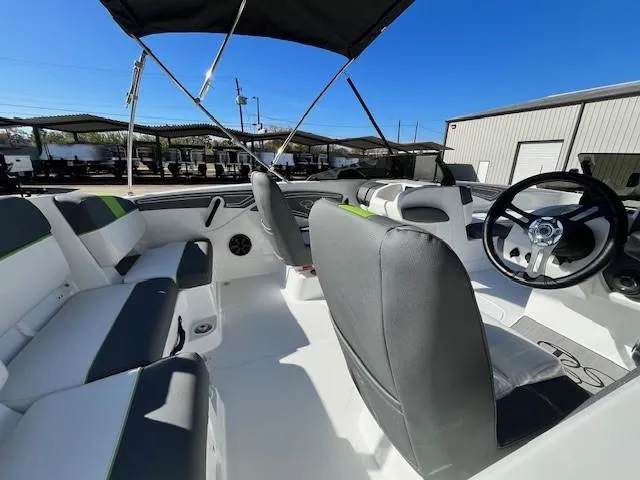 Slide: The Image of 2024 Tahoe T21 boat interior with seating and steering wheel under a canopy. - 4