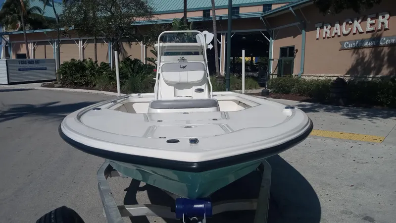 Slide: The Image of 2022 Mako 18 LTS boat on trailer outside Tracker dealership. - 2