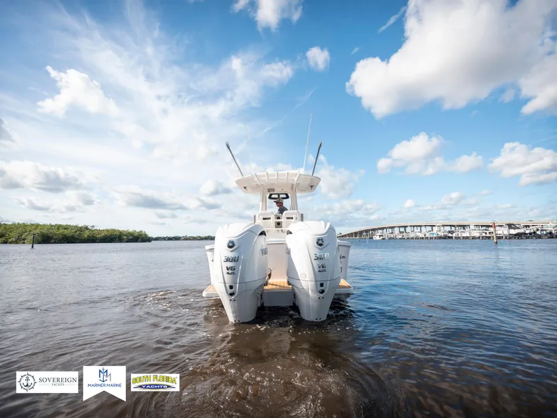 Slide: The Image of 2024 Regulator 28 boat on water, featuring dual engines under a clear blue sky. - 12