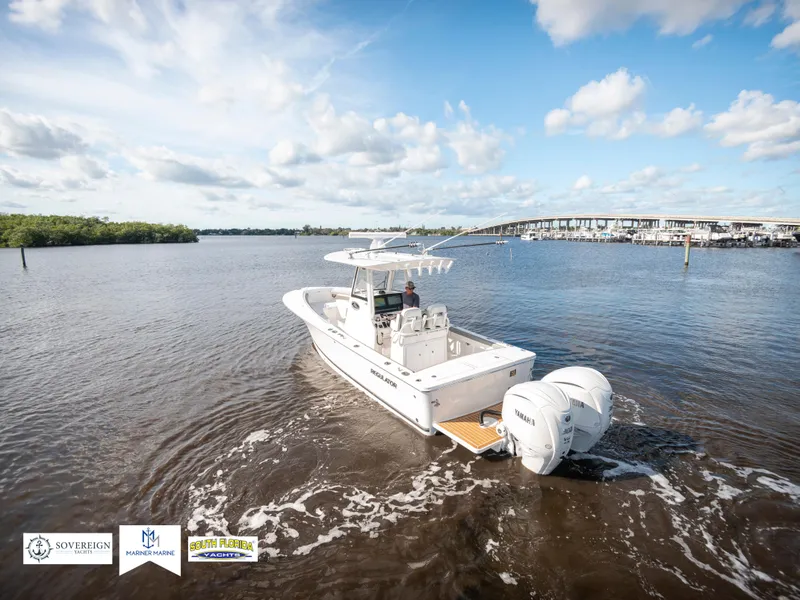 Slide: The Image of 2024 Regulator 28 boat cruising on a sunny day in open water. - 14