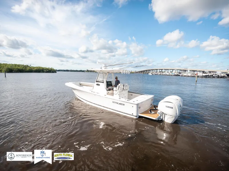 Slide: The Image of 2024 Regulator 28 boat on calm water with Yamaha engine, under a partly cloudy sky. - 15