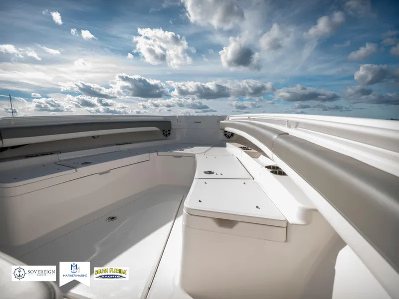 Slide: The Image of 2024 Regulator 28 boat deck under a cloudy sky. - 16