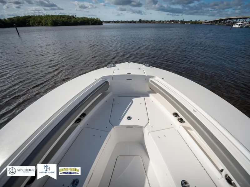 Slide: The Image of 2024 Regulator 28 boat on calm water, showcasing spacious deck and sleek design. - 18