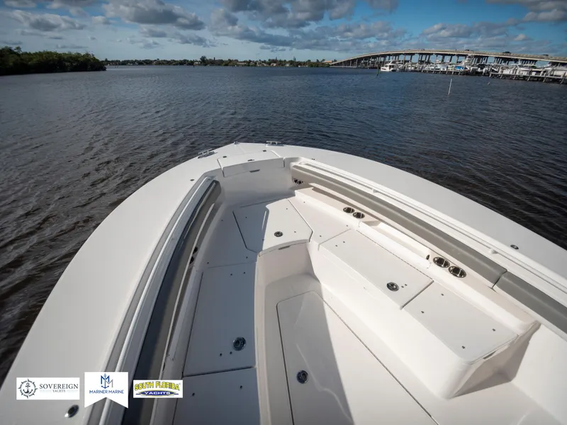 Slide: The Image of 2024 Regulator 28 boat on calm water with bridge in background. - 19