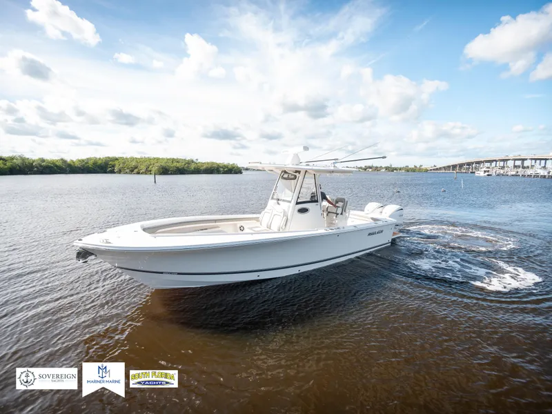 Slide: The Image of 2024 Regulator 28 boat cruising on a sunny day in open water. - 2