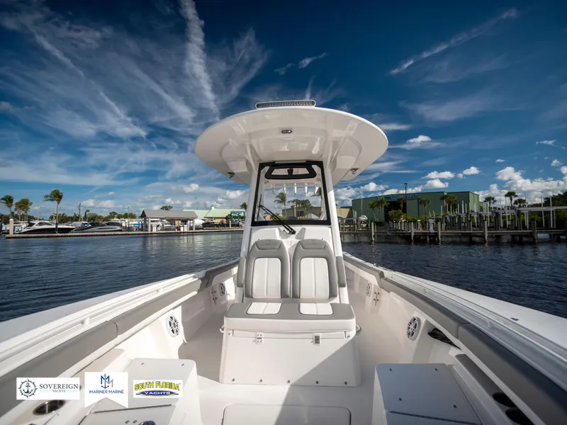 Slide: The Image of 2024 Regulator 28 boat on calm water under a clear blue sky. - 21
