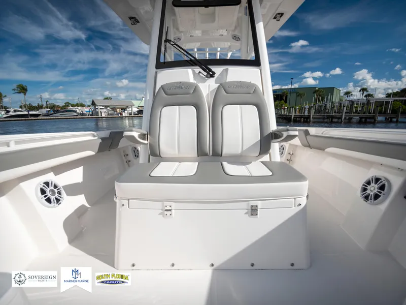Slide: The Image of 2024 Regulator 28 boat interior with dual seats and coastal view. - 22