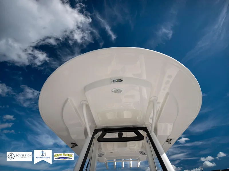 Slide: The Image of 2024 Regulator 28 boat against a vibrant blue sky with clouds. - 25