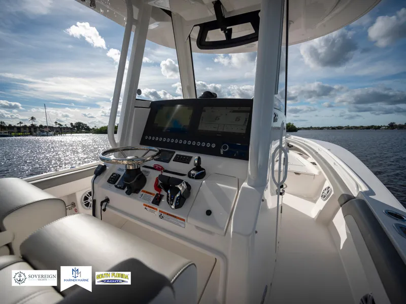 Slide: The Image of 2024 Regulator 28 boat cockpit with modern controls and scenic water view. - 26