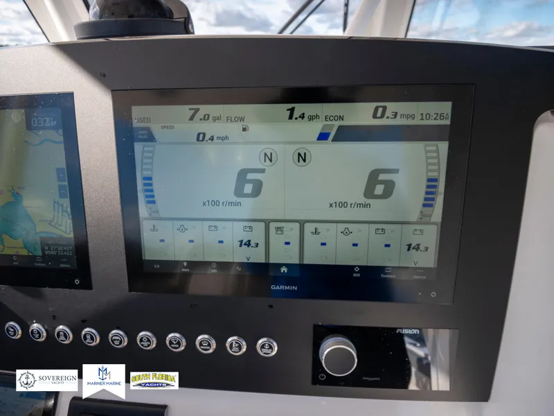 Slide: The Image of Dashboard of 2024 Regulator 28 boat with Garmin display showing engine metrics. - 29