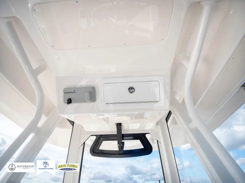 Slide: The Image of 2024 Regulator 28 boat interior with Garmin equipment and storage compartment. - 31
