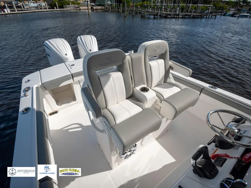 Slide: The Image of 2024 Regulator 28 boat with dual seats and twin engines on a calm water backdrop. - 36