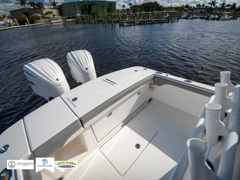 Slide: The Image of 2024 Regulator 28 boat with dual engines on a calm waterfront. - 38
