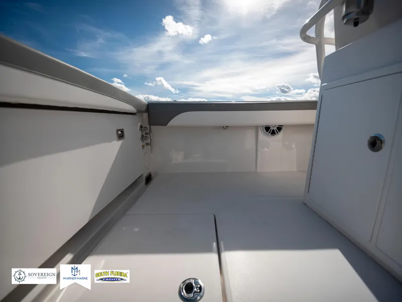 Slide: The Image of 2024 Regulator 28 boat interior with sleek white design under a bright blue sky. - 39