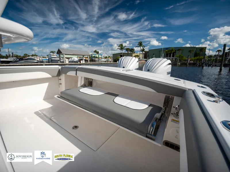 Slide: The Image of 2024 Regulator 28 boat interior with seating, docked under a vibrant sky. - 41