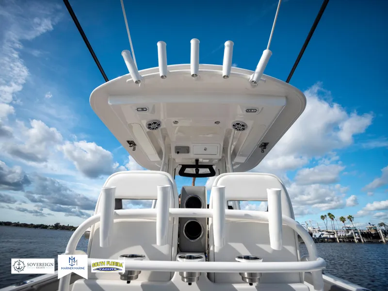 Slide: The Image of 2024 Regulator 28 boat, rear view, clear sky, ocean backdrop. - 44