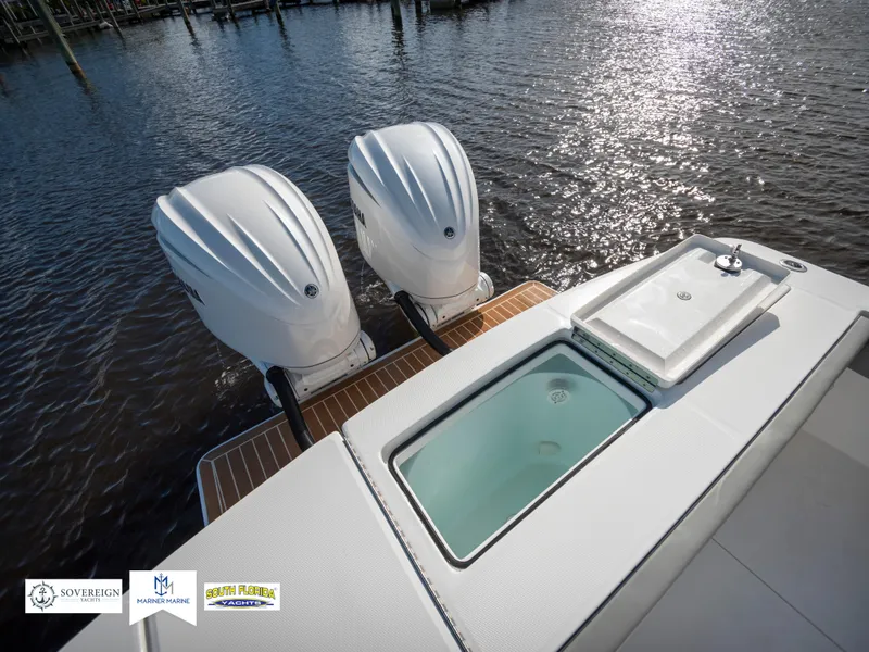 Slide: The Image of 2024 Regulator 28 boat with dual outboard engines and a livewell on a sunny day. - 45