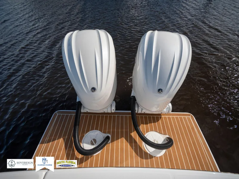 Slide: The Image of 2024 Regulator 28 boat with twin outboard engines on teak deck. - 46