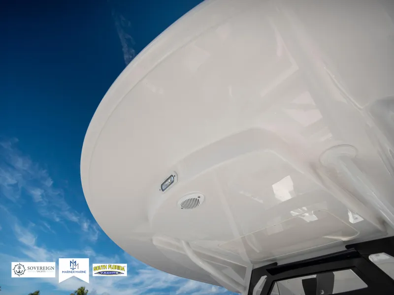 Slide: The Image of 2024 Regulator 28 boat, sleek design, under a clear blue sky. - 47