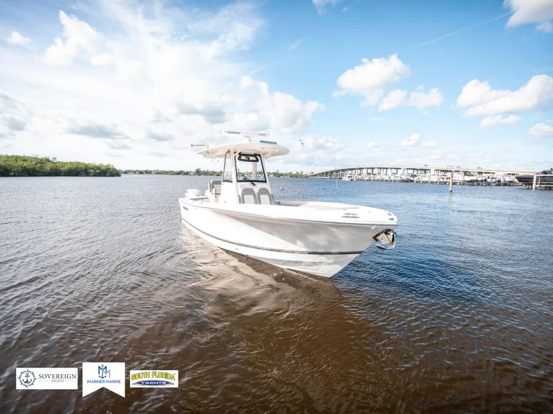 Slide: The Image of 2024 Regulator 28 boat on calm water under a blue sky. - 5