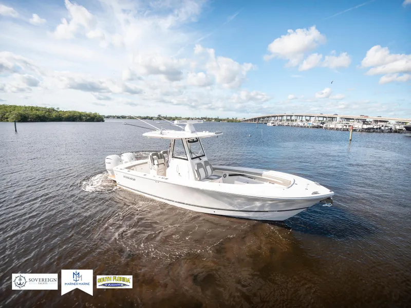 Slide: The Image of 2024 Regulator 28 boat cruising on a sunny day in open water. - 6