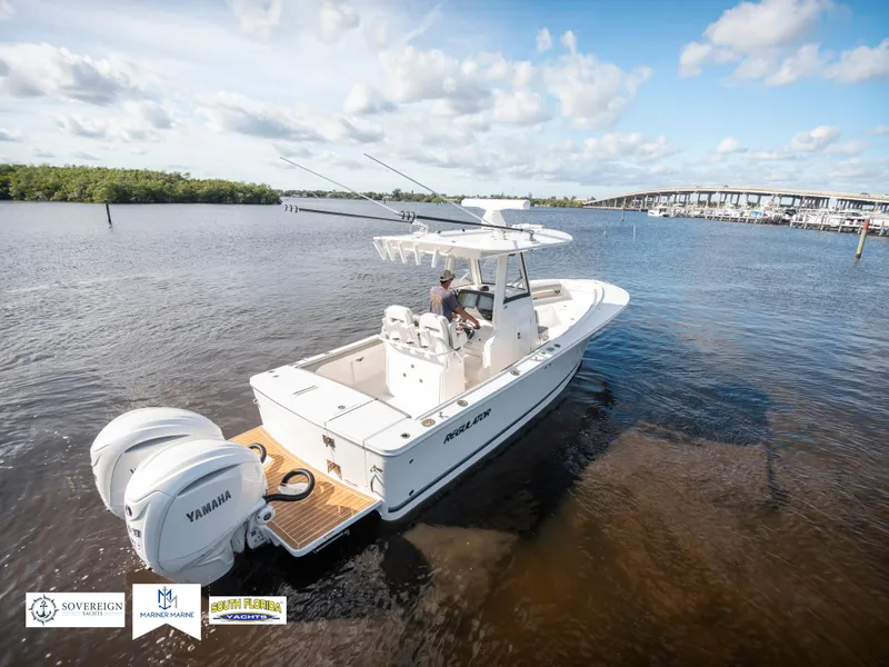 Slide: The Image of 2024 Regulator 28 boat on water with Yamaha engines, clear sky, and distant bridge. - 9
