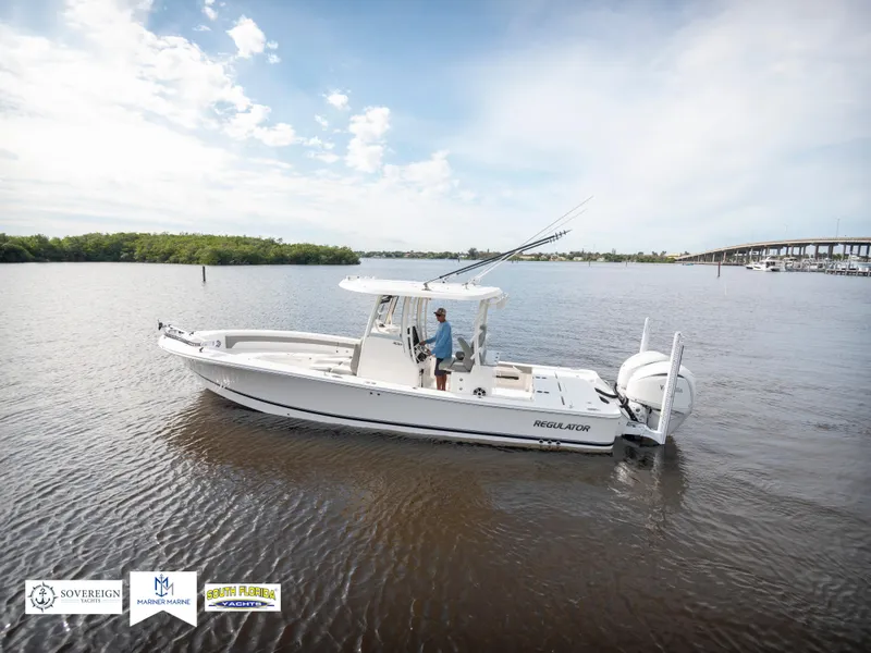 Slide: The Image of 2024 Regulator 30XO boat on calm water with clear sky. - 1
