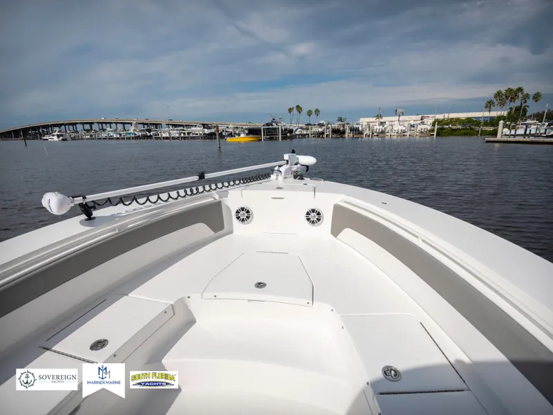 Slide: The Image of 2024 Regulator 30XO boat on calm waters with marina view. - 10