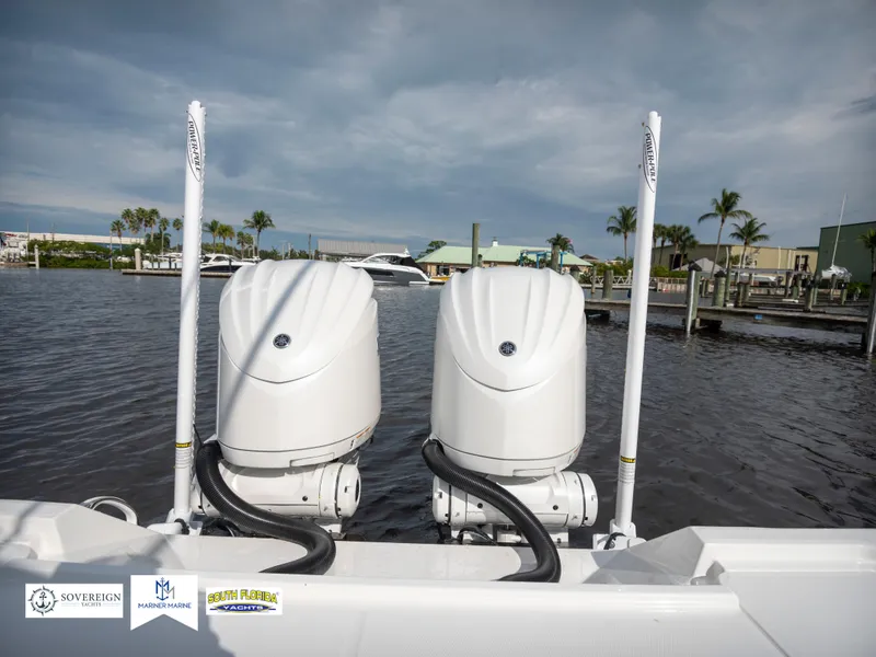 Slide: The Image of 2024 Regulator 30XO boat with dual outboard engines docked at marina. - 14