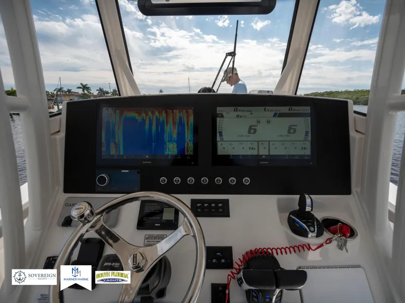 Slide: The Image of 2024 Regulator 30XO boat dashboard with advanced navigation displays and steering wheel. - 20