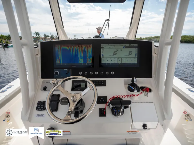 Slide: The Image of 2024 Regulator 30XO boat dashboard with advanced navigation displays and controls. - 21