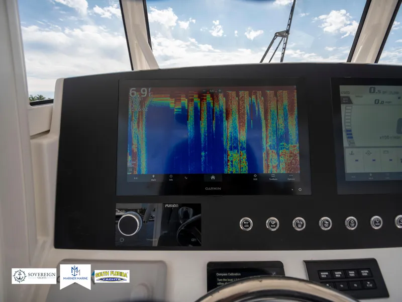 Slide: The Image of 2024 Regulator 30XO dashboard with Garmin display and sonar readings. - 22