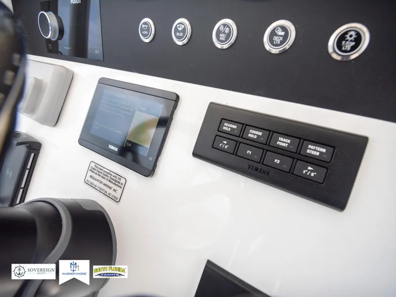 Slide: The Image of 2024 Regulator 30XO boat dashboard with Yamaha controls and digital display. - 24
