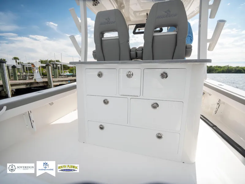 Slide: The Image of 2024 Regulator 30XO boat interior with storage drawers and seating. - 30