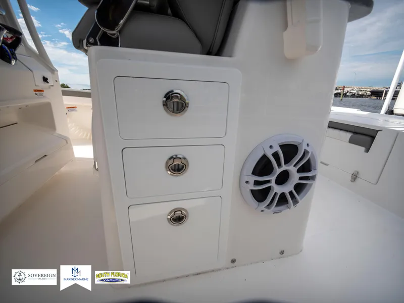 Slide: The Image of 2024 Regulator 30XO boat interior with storage drawers and speaker. - 33