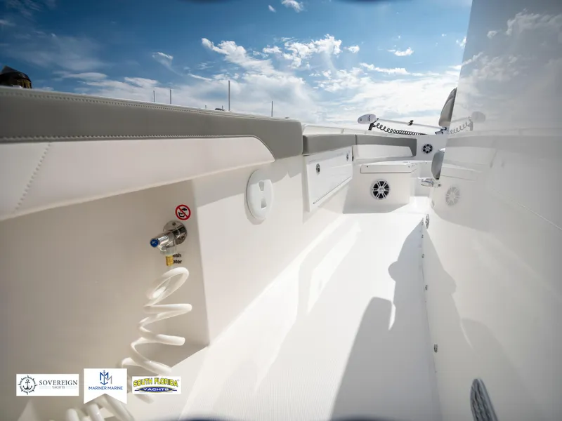 Slide: The Image of 2024 Regulator 30XO boat interior with white seating and deck, under a blue sky. - 34
