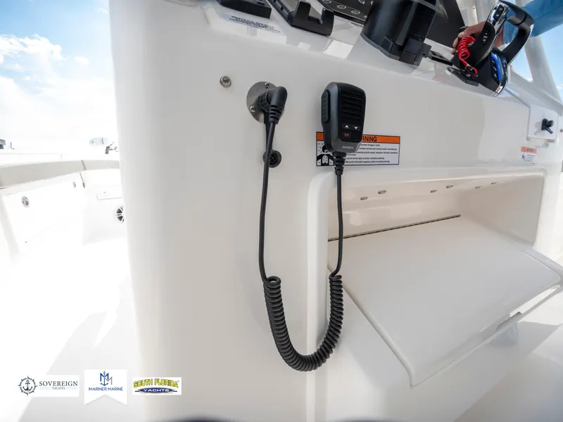 Slide: The Image of 2024 Regulator 30XO boat console with radio and storage compartment. - 38